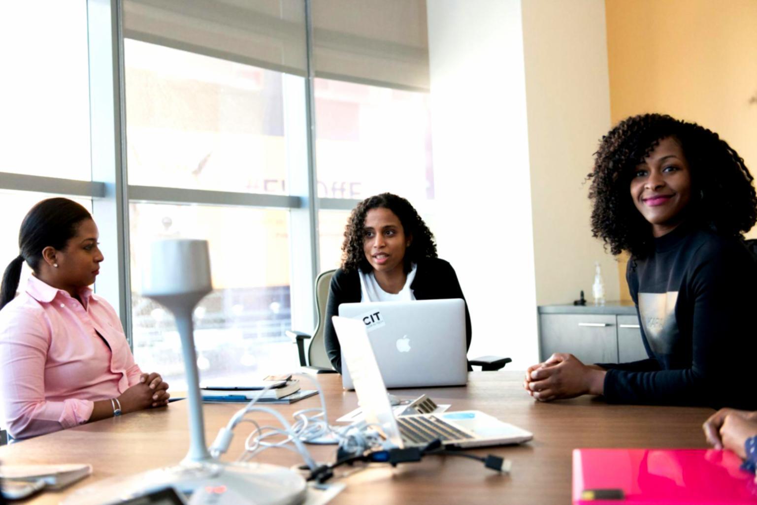 Professional financial consultation meeting showing budget planning and compliance documentation